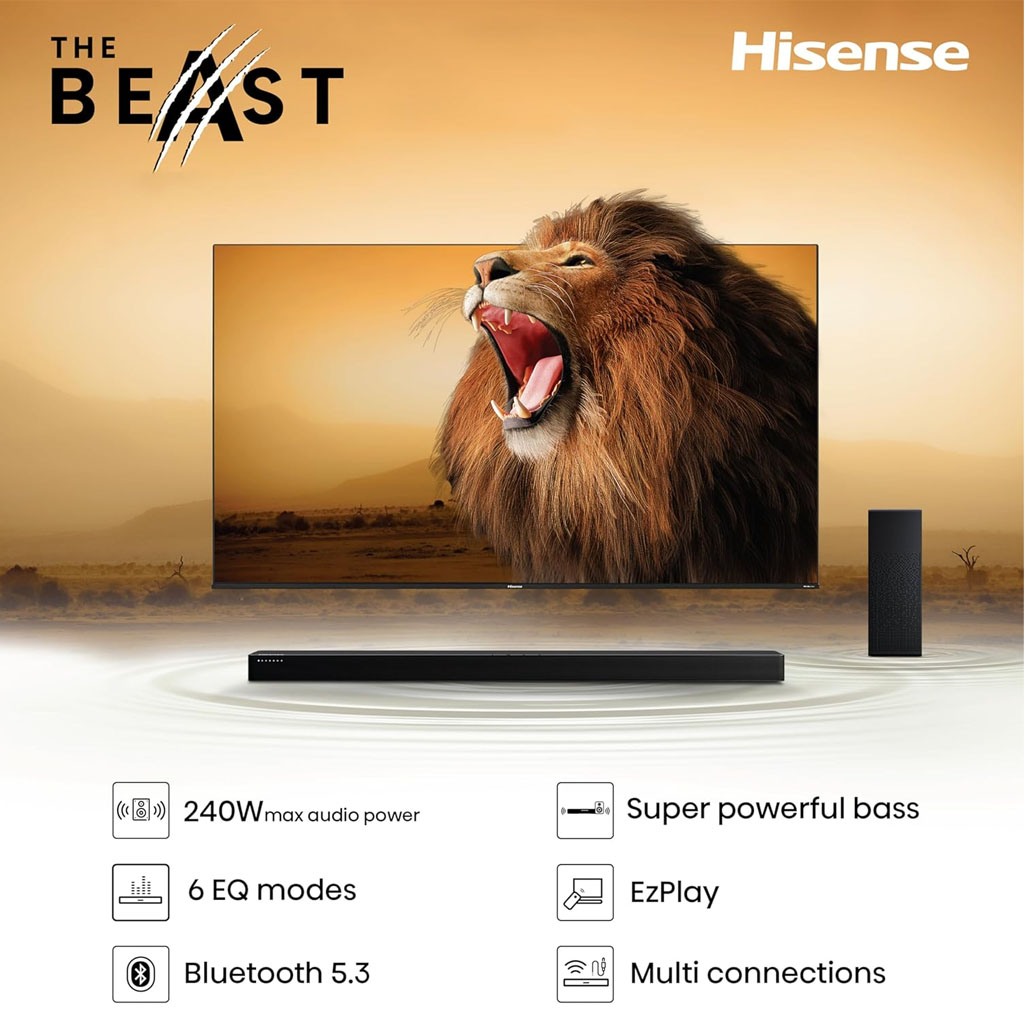 Black Hisense HS2100 2.1-channel soundbar positioned in front of a TV screen with a roaring lion graphic, accompanied by a separate wireless subwoofer to the side. The setup highlights the slim soundbar and tower-style subwoofer designed for enhanced home audio.
