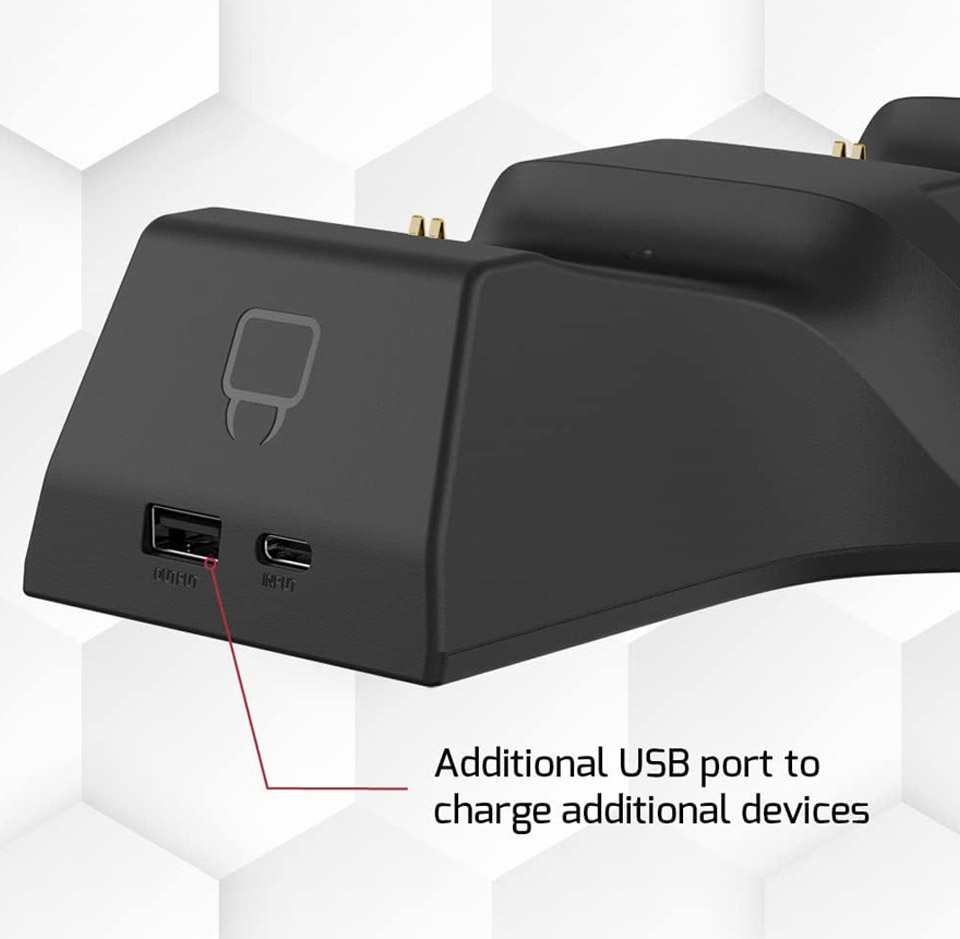 Close-up of the back of the Venom Twin Charging Dock - a black electronic charging dock featuring two USB ports on its side - one USB-A labelled “OUT” and one USB-C labelled “INPUT” A red line points to the USB-A port with text indicating it can charge additional devices. The dock has a minimalist "Venom" logo above the ports and is set against a white background with a subtle hexagonal pattern.