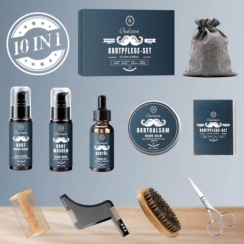 A neatly arranged 10‑in‑1 beard‑grooming kit is displayed against a light blue background. At the centre is a boxed set branded “Oukzon,” labelled as a natural beard‑care kit. Surrounding it are the included products: a grey drawstring pouch, small bottles of beard conditioner and beard wash, a dropper bottle of beard oil, a tin of beard balm, and a small instruction booklet. The tools include a wooden comb, a black plastic beard‑shaping tool with built‑in comb edges, a round wooden‑handled bristle brush, and a pair of grooming scissors. The layout highlights the variety of items in the set, presenting it as a complete solution for beard maintenance and styling.