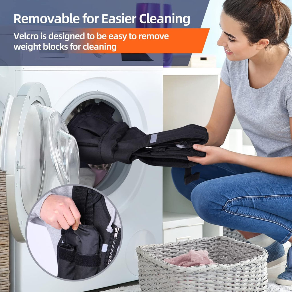 A person kneels beside a front‑loading washing machine, placing a black weighted vest inside. A laundry basket sits in the foreground. A small inset shows a close‑up of a hand pulling a weight block out of the vest pocket using Velcro, illustrating that the weights can be removed to make cleaning easier.